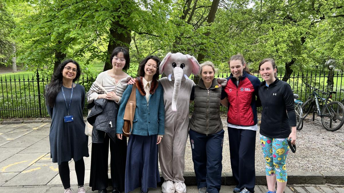 Small group of staff and students standing in George square after the Mile in the Meadows event