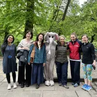 Person dressed in elephant costume standing with group of students