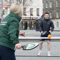 Woman and man playing paddleball
