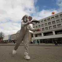 Person dressed in an elephant costume playing paddleball
